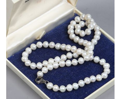 A cultured pearl necklace with silver clasp.