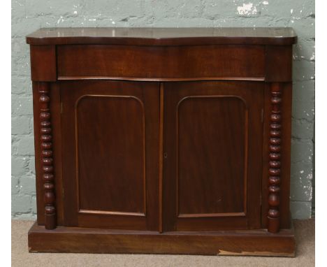 A Victorian mahogany serpentine chiffonier raised on turned bobbin supports.