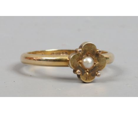 A 9ct gold ring with a seed pearl in quatrefoil setting, size P.