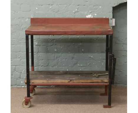 A vintage industrial portable steel work bench.