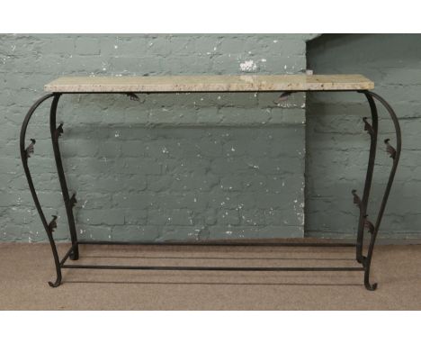 A wrought iron and yellow marble console table.