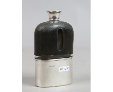 A Victorian silver and leather mounted hip flask, assayed London 1865.