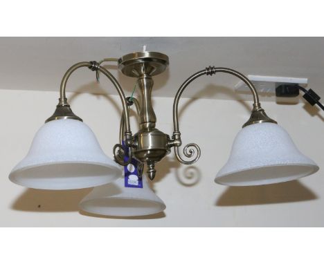 A brushed metal three branch hanging lamp with frosted glass shades.