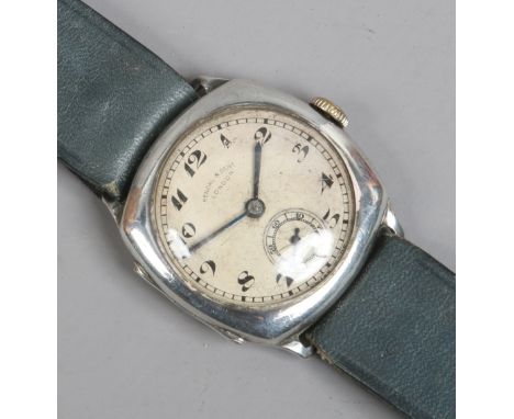 A boxed silver cased gentleman's manual wristwatch by Kendal & Dent with Arabic numeral marks and subsidiary seconds, assayed