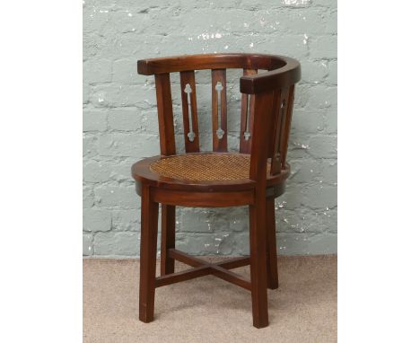 A hardwood bow back tub chair with bergere seat.