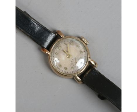 A ladies 9ct gold vintage Rolex Tudor manual wristwatch with applied Arabic numeral markers and subsidiary seconds.