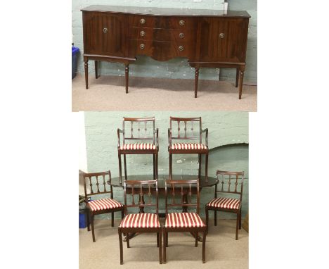 A Regency style mahogany three part dining room suite comprising bow front sideboard, twin pillar dining table and set of six