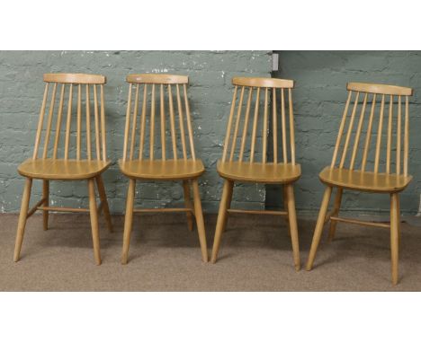 A set of four Ercol style spindle back dining chairs.