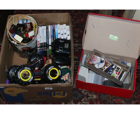 A box of toys, collectors cards, Diecast vehicles etc, along with console games and a remote controlled car.