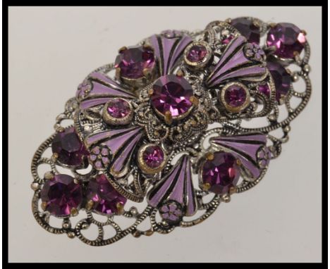 A vintage Czech plated filigree enamel and purple rhinestone brooch extensive filigree work with great 3d effect c clasp back