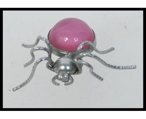 Vintage white metal spider brooch with large pink cabochon body. Measures 4cms