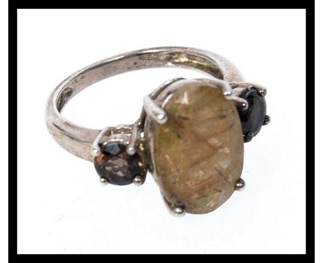 A 925 vintage ladies dress ring set with a central oval stone flanked by two darker smokey gems. Size Q. Weight 4.8g.