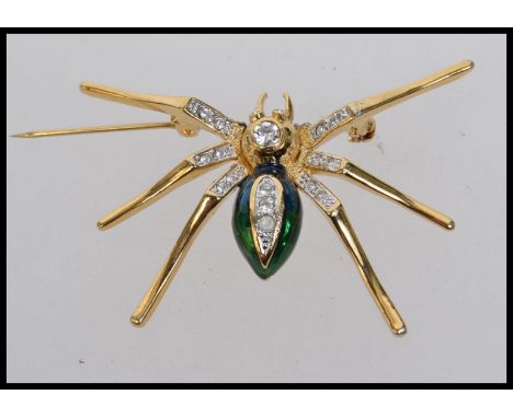A vintage yellow metal and green enamel spider brooch set with a diamonte body