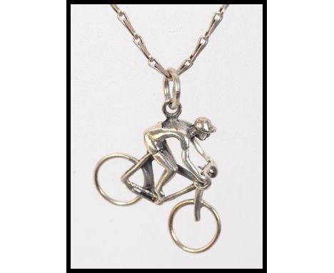 A 925 silver pendant necklace with fancy link chain and large vintage man on a bike pendant. weight 4.6g. Measures 16 inches.