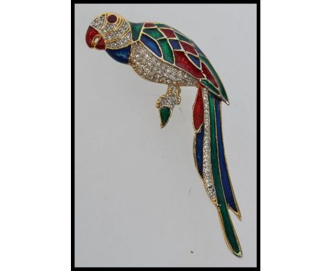 A large vintage parrot brooch decorated with vibrant red, green and blue enamel with pave set diamonte. Measures 9.5cms.