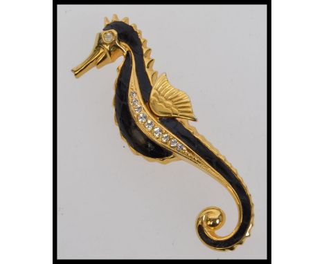 A large vintage yellow metal seahorse brooch with crocodile enamel and pave set diamonte body. Measures 8.5cms