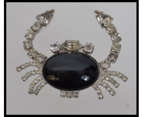 A large vintage crab brooch with central black cabochon  stone with paste set legs and claws. Measures 5cms.