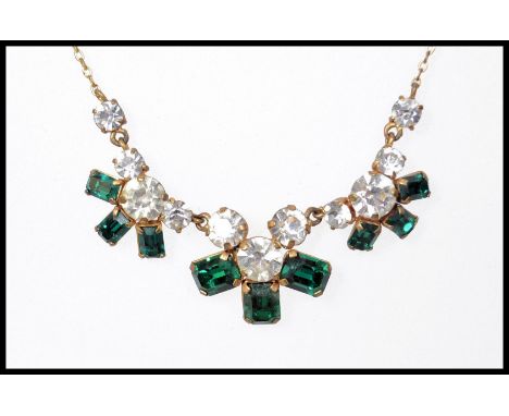 A vintage jewellery suite consisting of a necklace, clip-on earrings and brooch all set with emerald cut green paste stones a