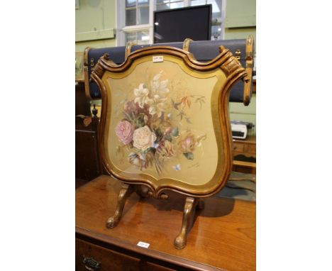 A 19th-century fancy scrawling, shield -shaped screen with hand painted floral panel by M M Sedgwick dated 1880 