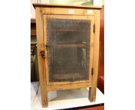 A first-quarter 20th-century pine food safe with traditional grill sides and single door 