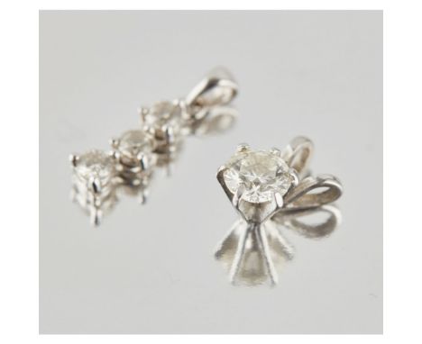 Two diamond set pendantsthe first claw set with a single round brilliant cut diamond, to a plain bale; together with another 