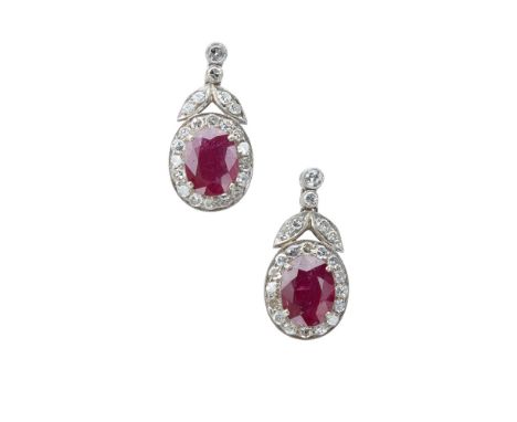 A pair of ruby and diamond set pendant earringseach claw set with an oval cut ruby in a single border of eight cut diamonds, 