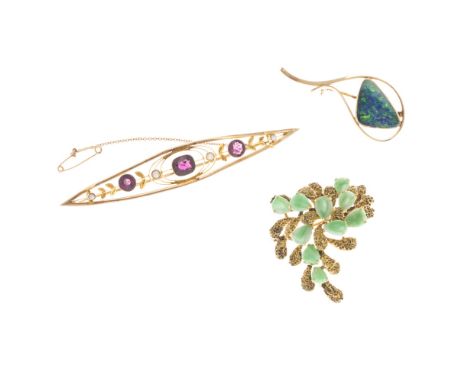 Three gem set broochesto include a contemporary black opal set brooch, indistinctly marked; a stylised jade set brooch of fol