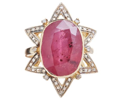 An early 20th century Russian ruby and diamond set ringcollet set with an oval cut ruby in a stylised angular surround set wi