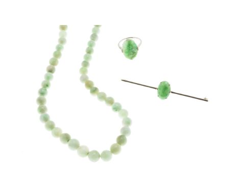 A collection of jade jewelleryto include a single strand of graduated jade beads, a bar brooch set with an oval jade cabochon