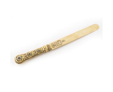 A late 19th century enamel and gem-set paper-knifethe yellow metal blade with chased foliate design at the handle, cast and o