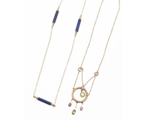 An early 20th century amethyst and peridot set necklaceof swag design, the circular motif with foliate detail, suspending var