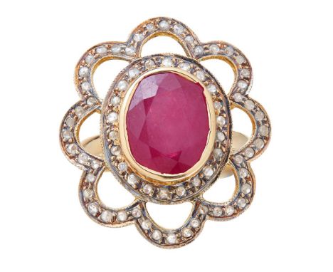 A Russian ruby and diamond set ringcollet set with an oval cut ruby, in a floral surround set with rose cut diamonds, to a pl