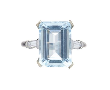 An aquamarine and diamond set cocktail ringclaw set with a trap cut aquamarine, each shoulder set with a tapered baguette cut