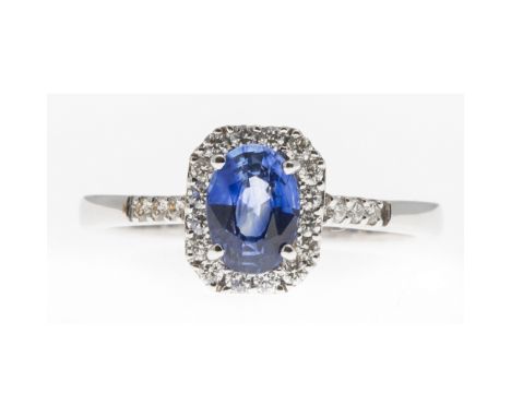 A sapphire and diamond set ringclaw set with an oval cut sapphire, in a single border of small round brilliant cut diamonds, 