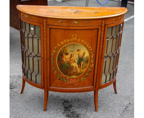 An 18th Century Style Sheraton Revival satinwood demi-lune commode, circa 1890, the top painted with urn of flowers with pear