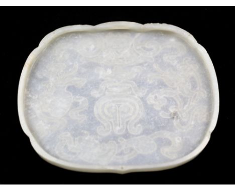 A Chinese light green jade plaque, late 19th / early 20th century, carved in low relief with shou character underneath paraso