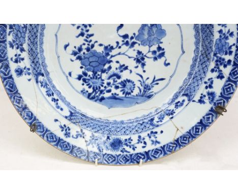 A Chinese blue and white porcelain large circular dish, Kangxi emperor (1662 - 1722), centrally with butterfly and blossoms, 