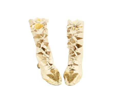 A pair of ladies court shoes in the style of booties, ivory satin, cut out lace design with louie heel and a motif of bronze 