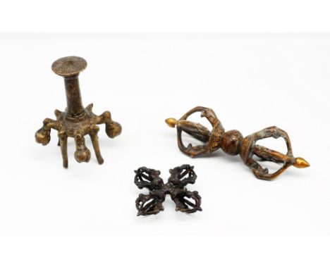 An Indo-Tibetan bronze small candlestick or stand, the engraved flat integral sconce engraved with panels, base with fruit / 