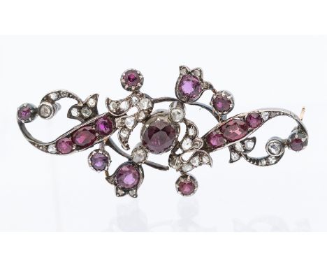 A 19th century ruby and diamond set gold and  platinum set brooch, comprising stone set scroll and foliate decoration, set wi