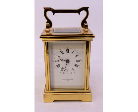 A Modern gilt metal carriage clock, white enamel dial with Roman Numerals, retailed by Richard Stone Derby, approx 15.5cm hig