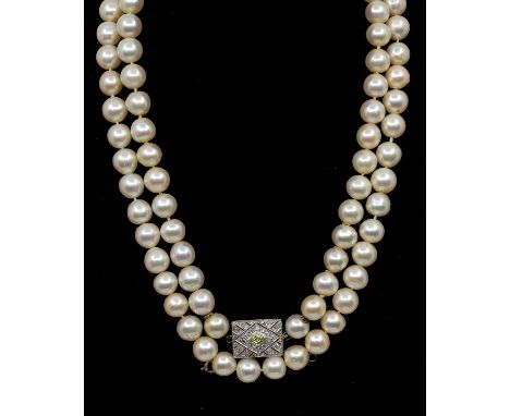 A cultured pearl necklace with diamond set clasp, comprising a single row of uniform pearls, each pearl measuring 8-8.5mm, st