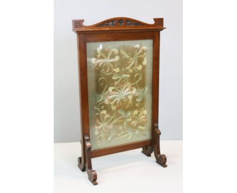Firescreen with embroidered floral and foliate decoration, scrolled feet and carved arch to top, height approximately 93cm
