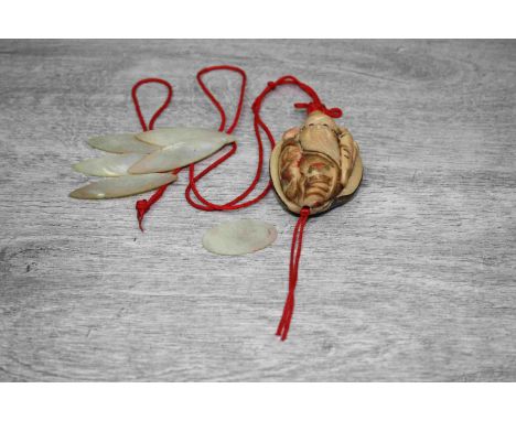 Oriental netsuke depicting an Elder with staff, coloured ink floral decoration to robes, length approximately 5.5cm together 