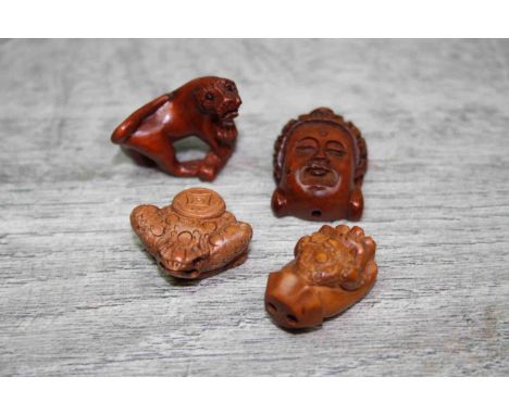 Four wooden miniature netsuke figures to include Buddha head, foo dog, etc