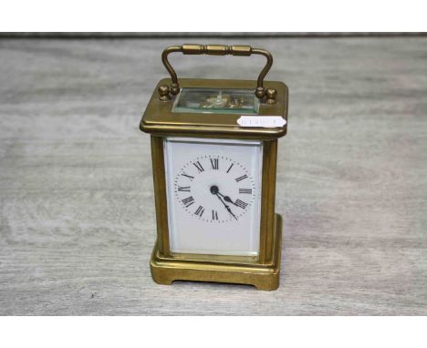 French brass cased carriage clock, white enamel dial with black Roman numerals and black poker hands, height approximately 11