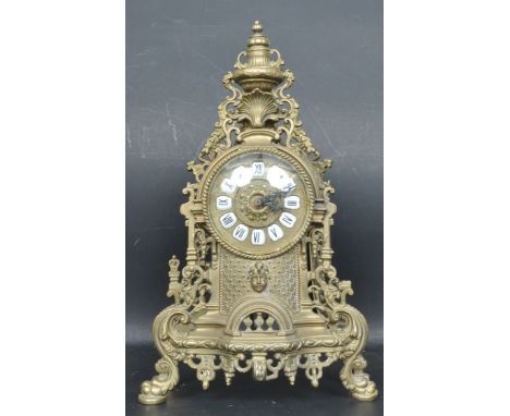 A 20th century vintage French style brass mantle clock. The clock having battery operated movement with brown white enamel nu