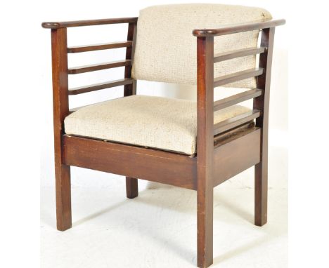 A retro vintage mid 20th century utility chair having a cushioned backrest and seat with shaped armrests raised on square sup