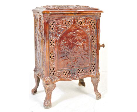 An early 20th century cast iron French Deville &amp; Co wood burning enamel stove, of oval form, raised on shaped supports, h