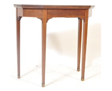 An Edwardian mahogany and box wood inlaid card / games table. Raised on square tapering legs having an angular fitted frieze.